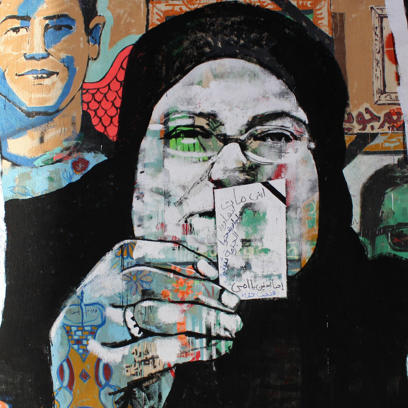 Graffiti mural of a woman holding a picture of a young boy