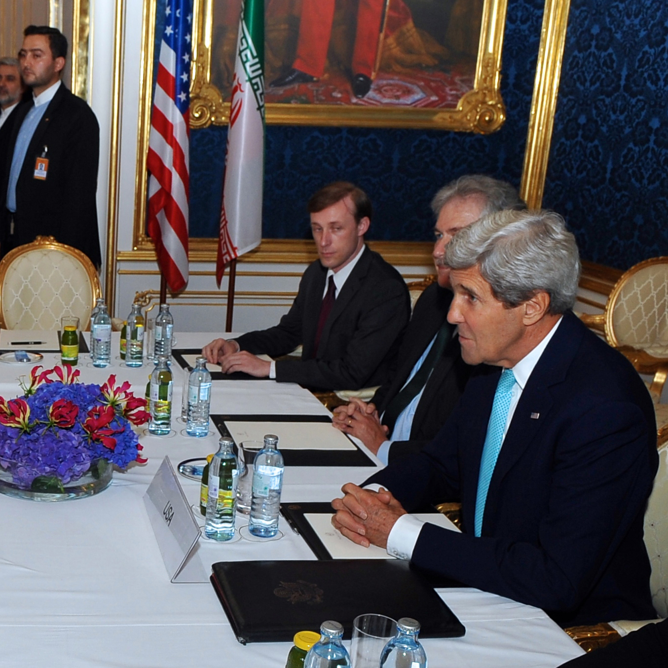 John Kerry siting a table with other American diplomats