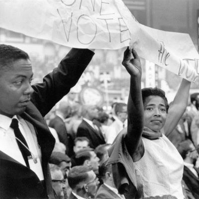 Civil rights protestors holding up a sign saying Vote