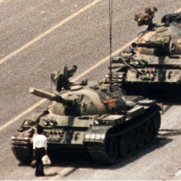 Man standing in front of a row of tanks