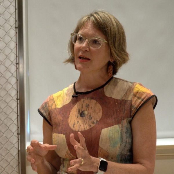 Kate Irvin wearing a colorful top with bold geometric designs as she appears in the video series for the Choices Program